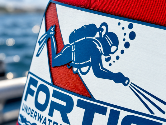 Close-up of the Fortis Underwater Recovery acrylic tri-layer patch on the red Richardson 112 trucker hat